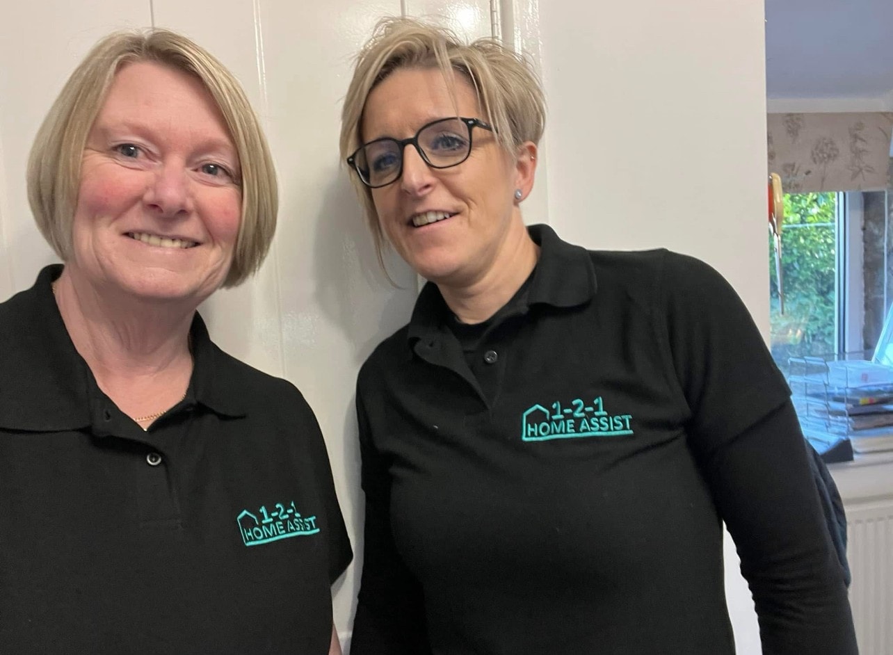 Two 1-2-1 Home Assist team members smiling
