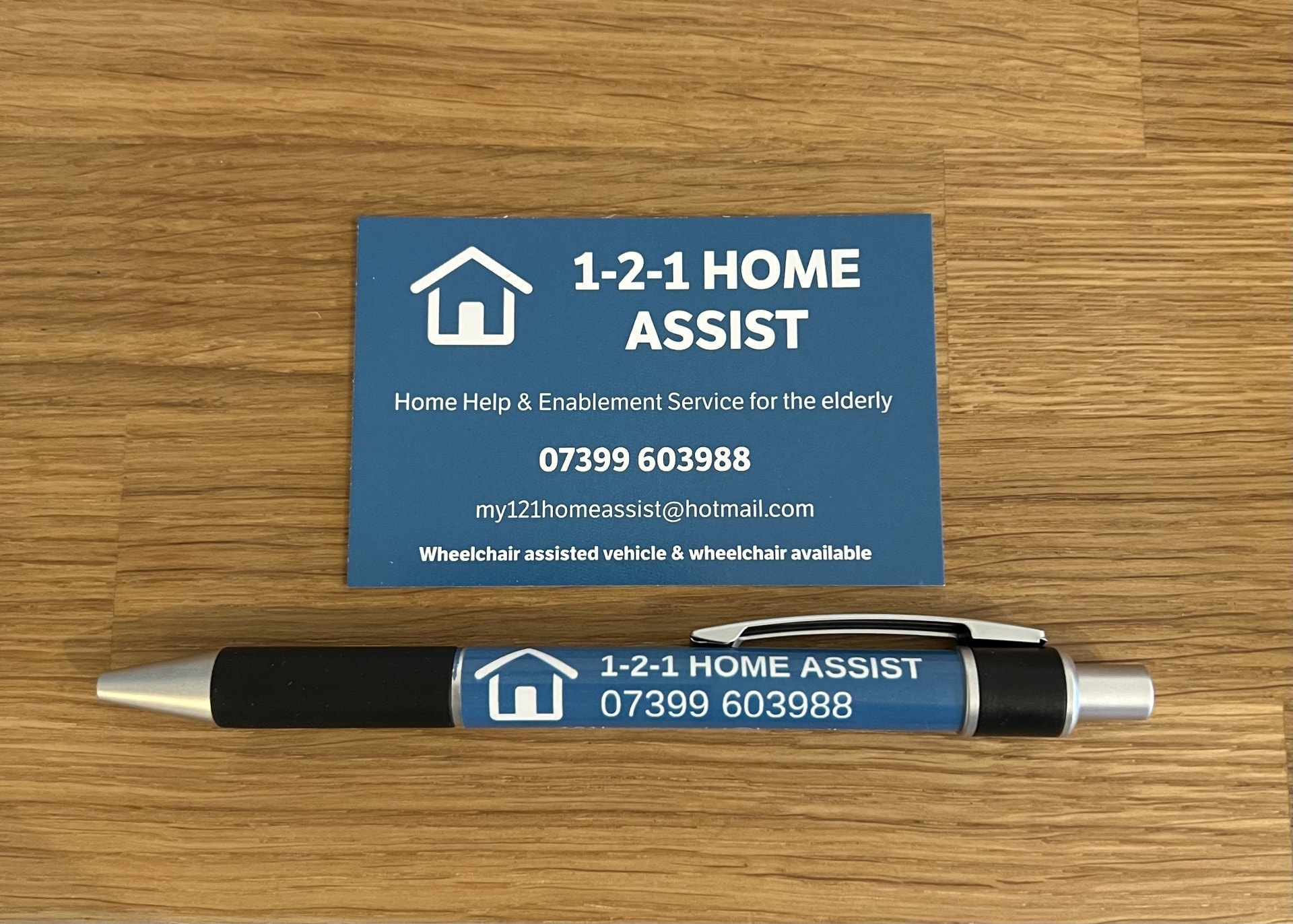 1-2-1 Home Assist business card and pen
